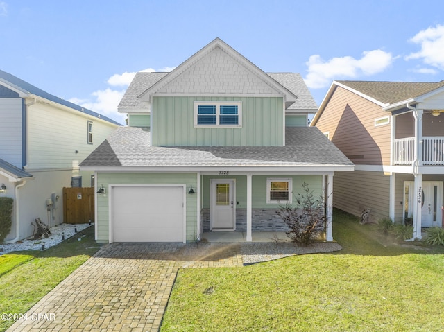 view of front of house featuring board and batten siding, decorative driveway, roof with shingles, and a front lawn