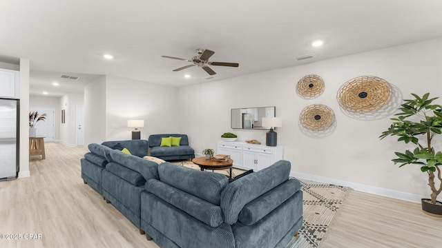 living room featuring recessed lighting, visible vents, baseboards, and light wood-style flooring