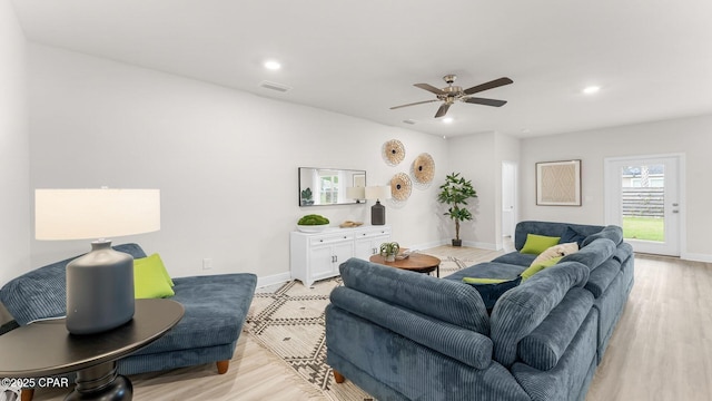 living room with light wood finished floors, visible vents, and recessed lighting