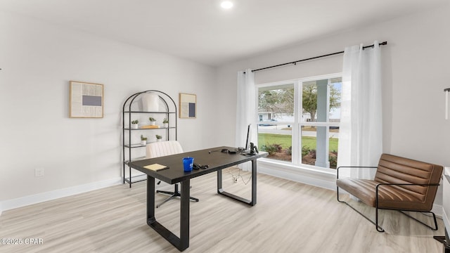 office featuring light wood-style flooring and baseboards