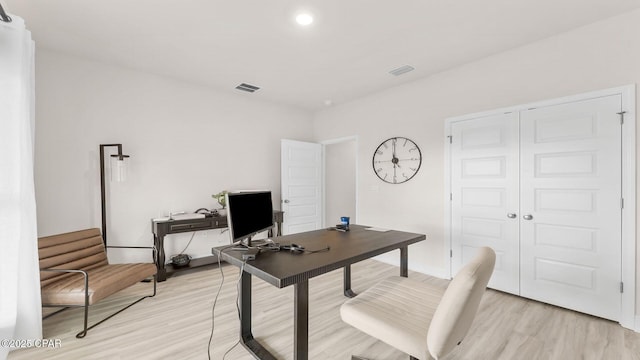 office featuring light wood-style floors and visible vents