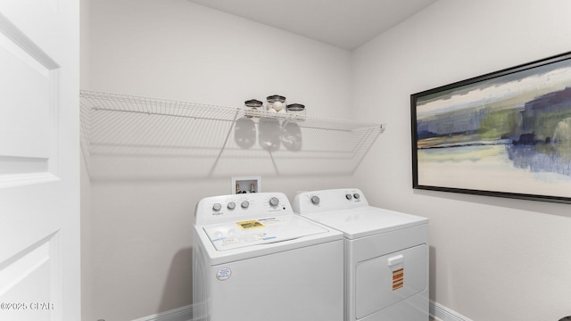 laundry area with laundry area, baseboards, and independent washer and dryer