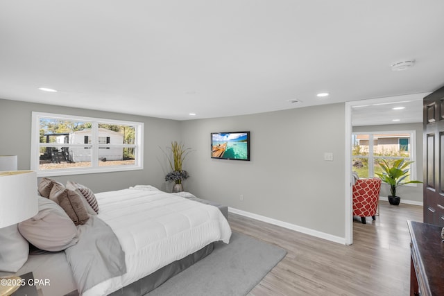 bedroom with recessed lighting, baseboards, and light wood finished floors