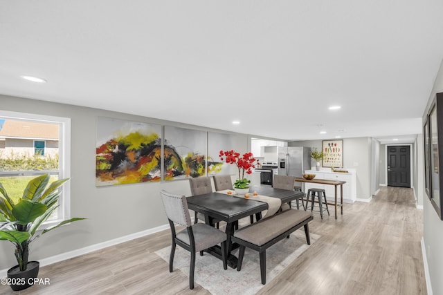 dining room with recessed lighting, light wood-type flooring, and baseboards