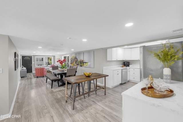 dining area featuring light wood-type flooring, visible vents, baseboards, and recessed lighting