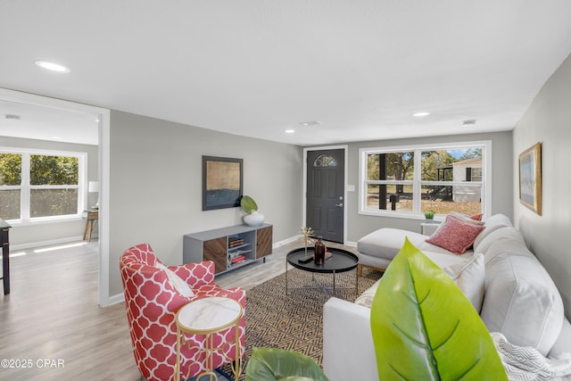 living room with recessed lighting, baseboards, and wood finished floors