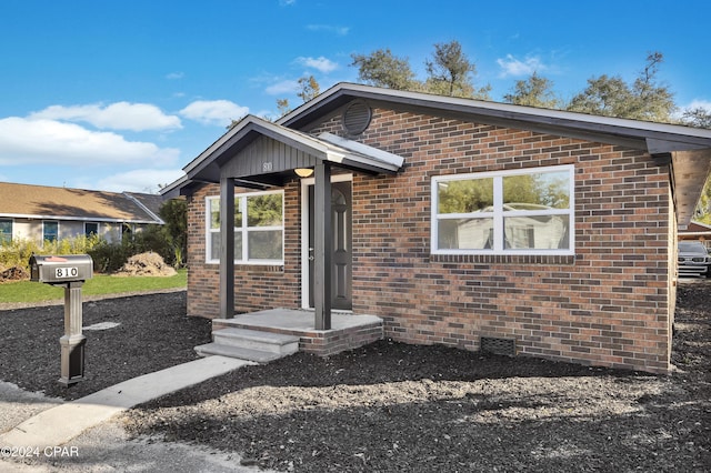 bungalow-style home featuring brick siding