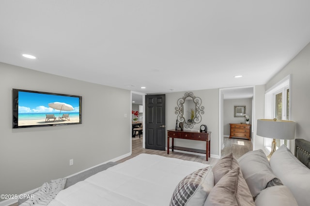 bedroom with recessed lighting, baseboards, and light wood finished floors