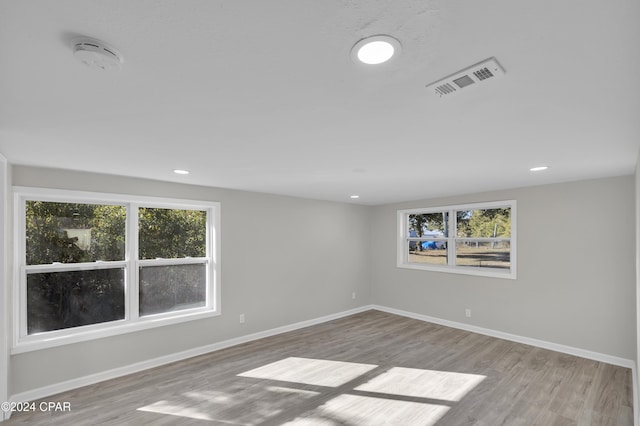 spare room with light hardwood / wood-style flooring