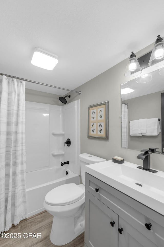 bathroom featuring shower / bath combo, toilet, vanity, and wood finished floors