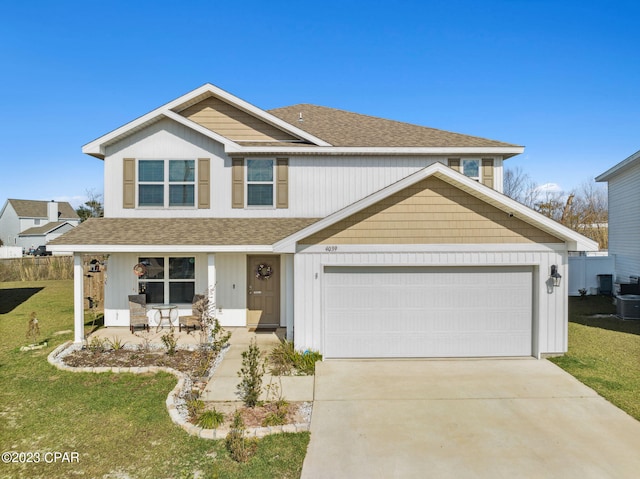 view of front of house featuring driveway, a shingled roof, a porch, and a front yard