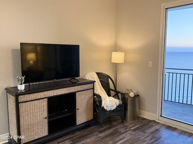 interior space with a water view and dark hardwood / wood-style floors