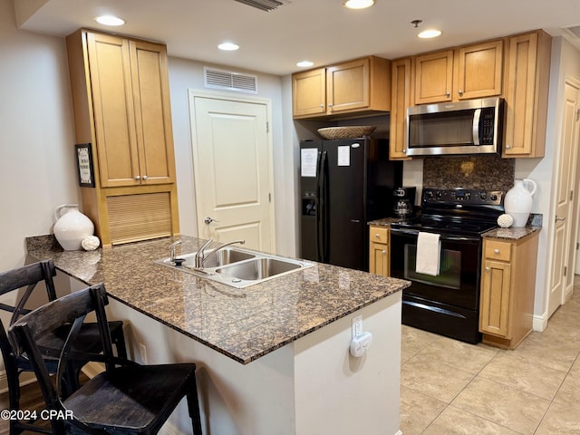 16701 Front Beach Rd Unit 1605, Panama City Beach, FL 32413 - kitchen featuring black appliances, a peninsula, a kitchen breakfast bar, recessed lighting, and decorative backsplash
