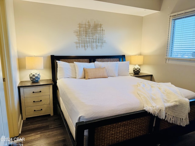 bedroom with dark hardwood / wood-style flooring