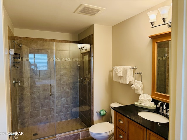 bathroom featuring an enclosed shower, vanity, and toilet