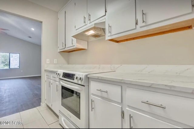 kitchen featuring lofted ceiling, electric range oven, and light tile patterned floors