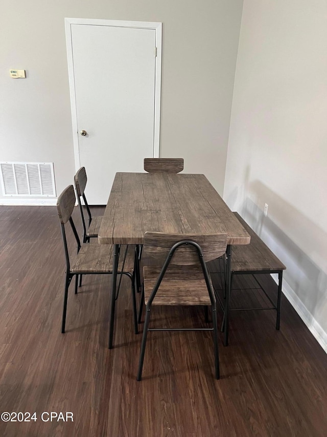 dining space with dark hardwood / wood-style flooring