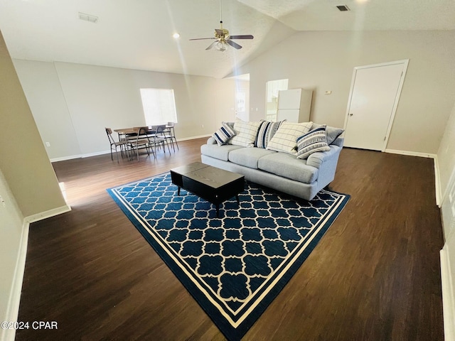 living room featuring vaulted ceiling, dark hardwood / wood-style floors, and ceiling fan