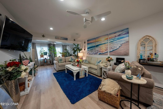 living room featuring light wood-type flooring and ceiling fan