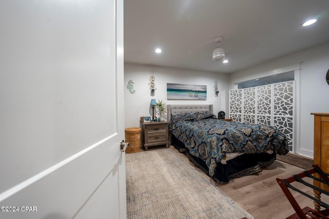 bedroom with ceiling fan and wood-type flooring