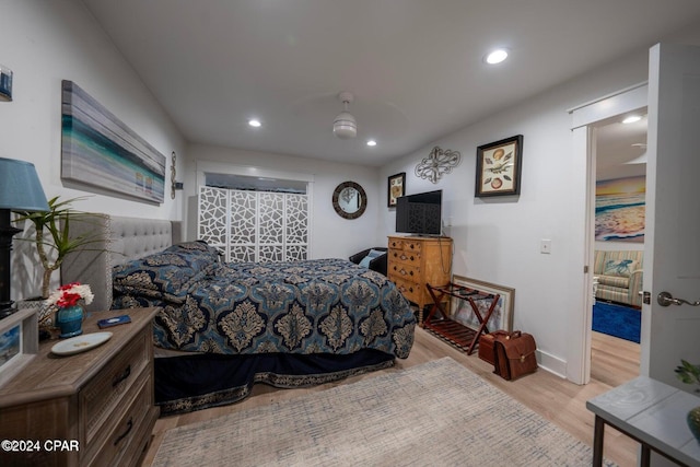 bedroom featuring ceiling fan and light hardwood / wood-style floors