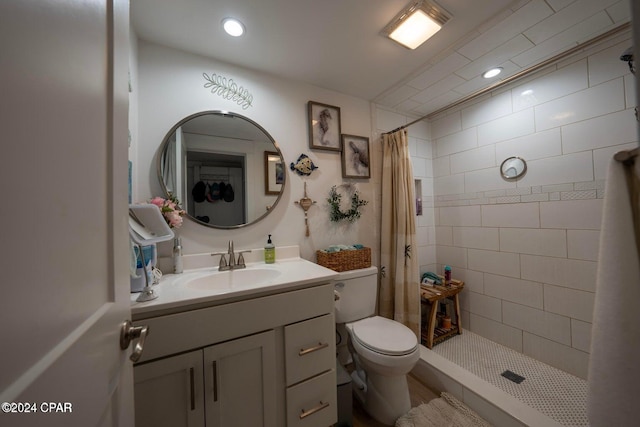 bathroom with walk in shower, vanity, and toilet