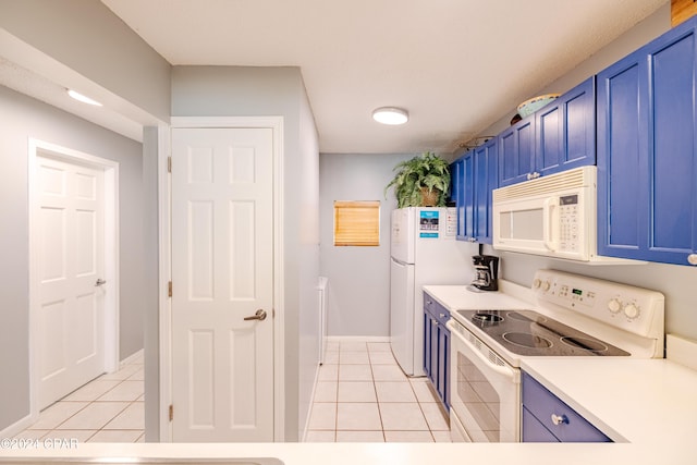 kitchen with blue cabinetry, white appliances, and light tile patterned flooring