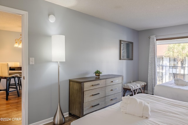 bedroom featuring hardwood / wood-style floors and a textured ceiling