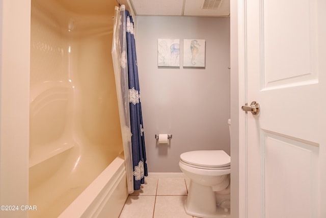 bathroom featuring toilet, shower / tub combo, and tile patterned floors