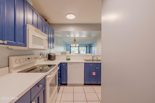 kitchen featuring blue cabinetry, light tile patterned flooring, white appliances, and sink