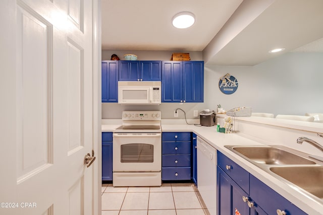 kitchen featuring blue cabinetry, white appliances, sink, and light tile patterned flooring