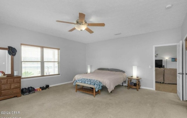 bedroom with light colored carpet and ceiling fan