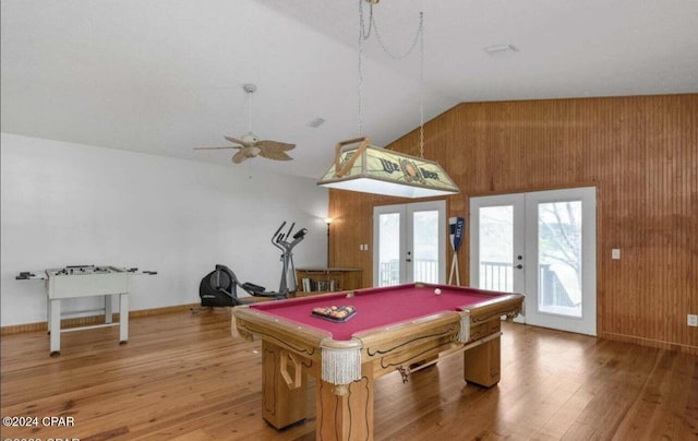 game room featuring french doors, wood walls, pool table, vaulted ceiling, and hardwood / wood-style floors