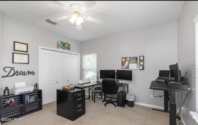 carpeted office featuring ceiling fan