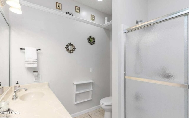 bathroom with tile patterned floors, toilet, a shower with door, and vanity