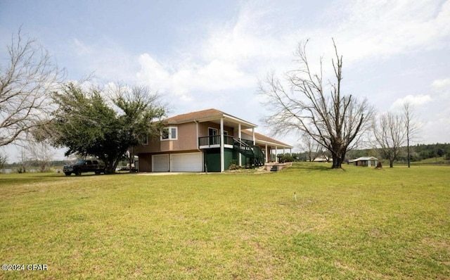 view of yard featuring a wooden deck and a garage