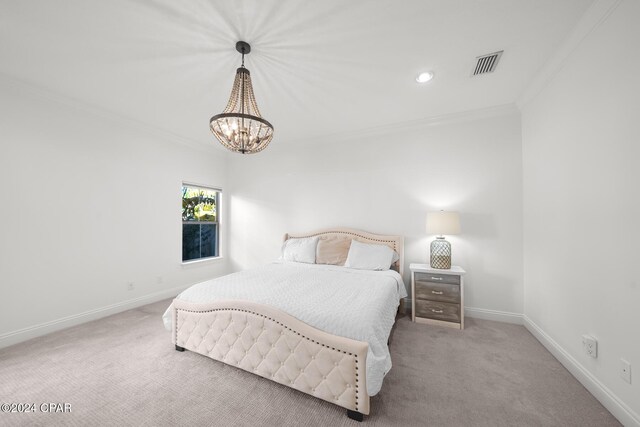 carpeted bedroom featuring ornamental molding and a notable chandelier