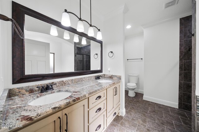 bathroom featuring vanity, ornamental molding, an enclosed shower, and toilet