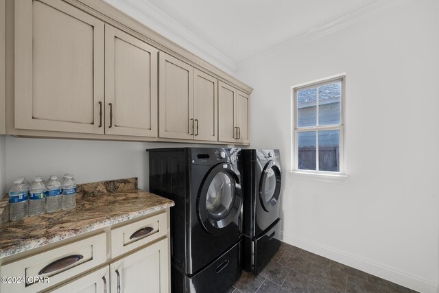 laundry room featuring cabinets, ornamental molding, and washing machine and clothes dryer