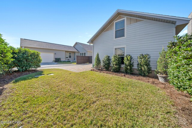 rear view of property featuring a yard