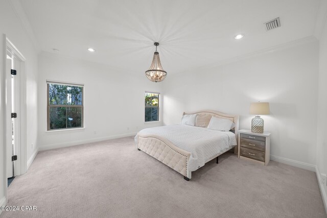 carpeted bedroom featuring an inviting chandelier and ornamental molding