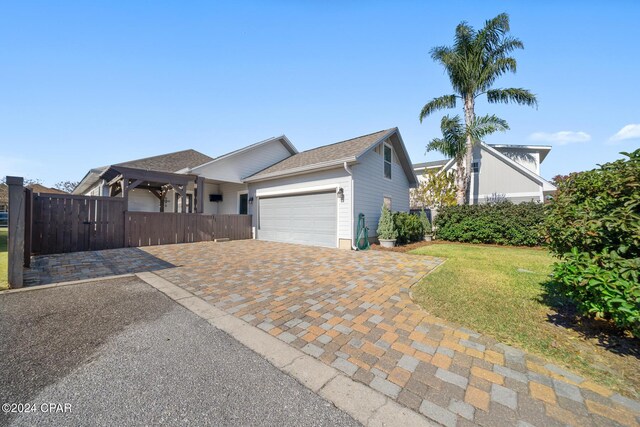 single story home featuring a front yard and a garage