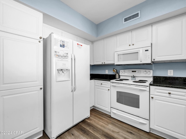 kitchen featuring white appliances, visible vents, white cabinets, and dark wood-type flooring