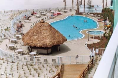 view of swimming pool with a patio and fence