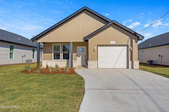 view of front of property featuring board and batten siding, a front yard, cooling unit, driveway, and an attached garage