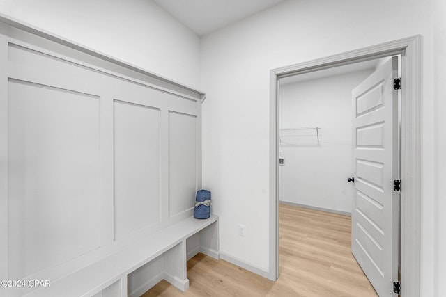 mudroom featuring baseboards and light wood finished floors