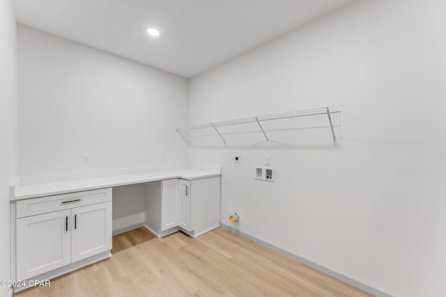 laundry room featuring hookup for a washing machine, baseboards, light wood-style flooring, cabinet space, and electric dryer hookup