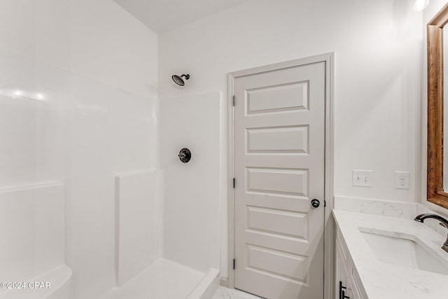 bathroom with vanity and a shower