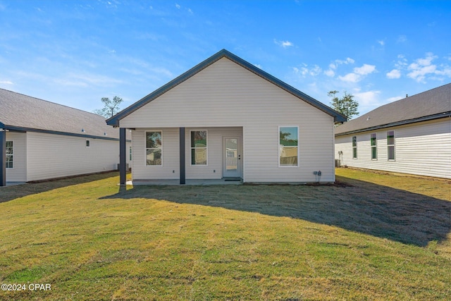 rear view of property with a yard