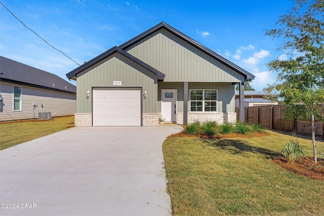 view of front of home featuring fence, cooling unit, concrete driveway, a front yard, and a garage